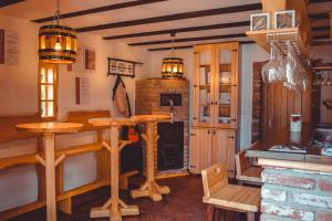 a kitchen with a table and a bar in a room at Vinska kuća na vinskoj cesti Zmajevac in Zmajevac +35 photos