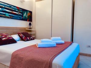 a bedroom with a bed with towels on it at Villino I Pini in Marciana Marina