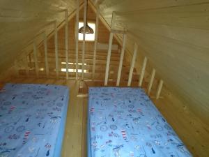 a bed in the middle of a room in a attic at Aadel Guesthouse in Pärnu