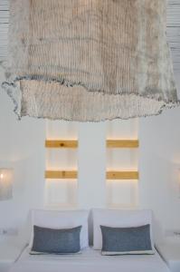 A bed or beds in a room at Yialos Ios Hotel