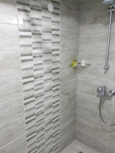 a bathroom with a shower with a glass door at Hotel Cingo in Ohrid