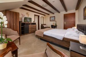 a bedroom with a large bed and a living room at My Soul Resort in Knić
