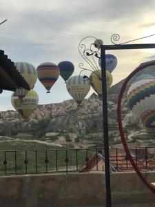 a group of hot air balloons flying in the sky at Rose Valley Hotel in Goreme