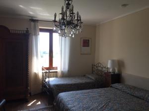 Łóżko lub łóżka w pokoju w obiekcie VILLA LE ROSE