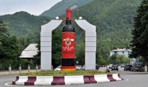 a statue of a bottle of wine on the side of a road at Villa PorTina in Ambrolauri