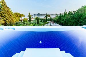 a pool with a view of the water and trees at Lamasu RioVerde - Lago di Garda in San Felice del Benaco