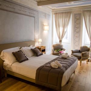 Un dormitorio con una cama grande con dos animales de peluche. en San Pier Novello in Oltrarno, en Florencia