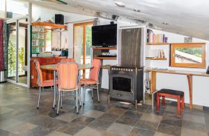 a living room with a table and a stove at Studio avec vue panoramique in Puget-Théniers