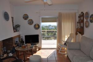 A television and/or entertainment centre at Javea Lovely Apartments Facing the Sea