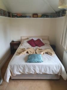 a bed with two pillows and a blanket on it at Old Coach House in Birchington