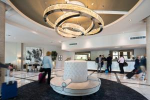 a lobby with a large chandelier and a cake in the middle at Park Regis Birmingham in Birmingham