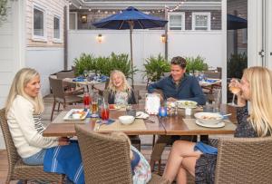 two women sitting at a table with plates of food at The Nantucket Hotel & Resort in Nantucket