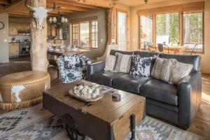 a living room with a leather couch and a coffee table at Moonlight Mountain Home-9 Indian Summer in Big Sky Mountain Village