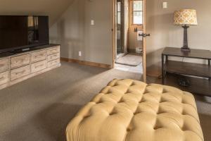a living room with a couch and a television at Moonlight Mountain Home-9 Indian Summer in Big Sky Mountain Village