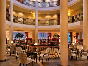 a lobby of a hotel with tables and chairs at Travel Charme Strandidyll Heringsdorf in Heringsdorf