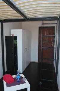 a room with a white table and a black refrigerator at Pokoje w cichym mieszkaniu 50m od Rynku in Wrocław +4 photos