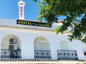 a building with a sign for a hospital in takyatown at Hostal la Tarayuela in Barbate