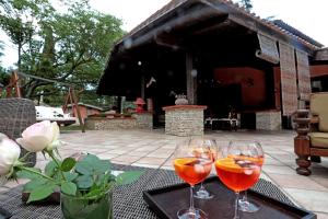three wine glasses sitting on a table on a patio at I Lari Castel Del Monte in Castel del Monte