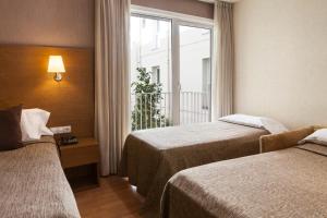 Postel nebo postele na pokoji v ubytování Hotel Don Paco