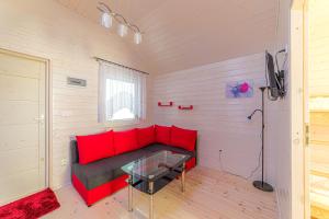 a living room with a red couch and a television at Pod Gruszą Wicie in Wicie +39 photos