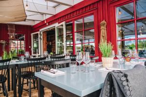 a restaurant with tables and chairs and red walls at Skatans Café & Krog in Skatan