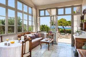 a living room with a couch and a table at DellaGracia Mansion in Poseidonia Syros in Posidhonía