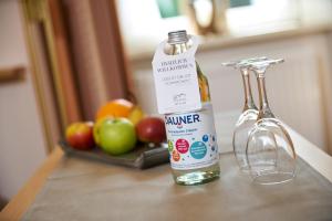 a bottle of vinegar sitting on a counter with apples at Landhotel Krolik in Daun