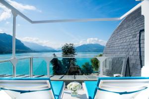 a view of the water from the balcony of a house at Impérial Palace in Annecy