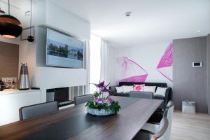 a living room with a table and a couch at Impérial Palace in Annecy