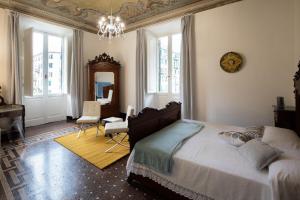 a bedroom with a bed and a desk and a mirror at Corso Mazzini in Savona