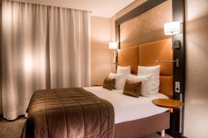 a hotel room with a bed in a room at Impérial Palace in Annecy