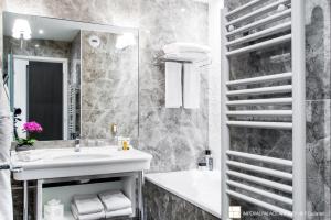 a bathroom with a sink and a mirror at Impérial Palace in Annecy