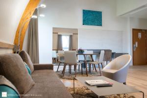 a living room with a couch and a table at Impérial Palace in Annecy