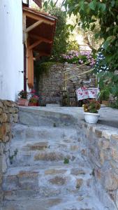 a stone steps leading to a building with a bench at La porta del Sole in Seborga