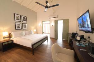 a bedroom with a bed and a flat screen tv at Angel Beach Unawatuna in Unawatuna