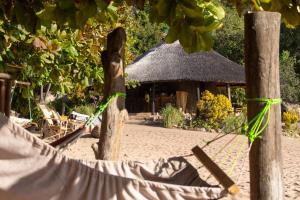 a resort with a straw hut in the background at Mufasa Eco Lodge in Monkey Bay
