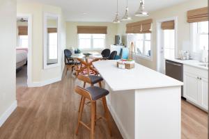 a kitchen and living room with a table and chairs at The Hotel Maria in Westerly