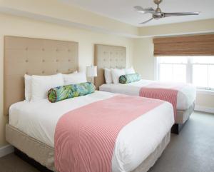 a bedroom with two beds and a ceiling fan at The Hotel Maria in Westerly