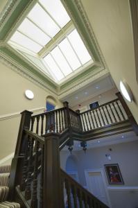 a large staircase leading up to a balcony at Palmerston Suites in Edinburgh