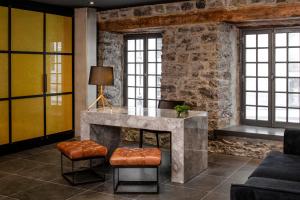 a living room with a table and two stools at William Gray by Gray Collection in Montréal