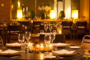 a table in a restaurant with candles and wine glasses at Starhotels Tuscany in Florence