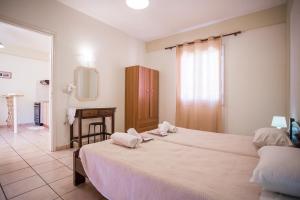 Postel nebo postele na pokoji v ubytování Theodora Corfu Holiday Apartments