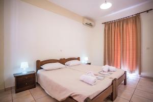 Postel nebo postele na pokoji v ubytování Theodora Corfu Holiday Apartments