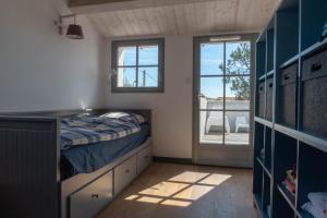 a small bedroom with a bed and a sliding glass door at Sea-Snow Guest Houses in Talmont +44 photos