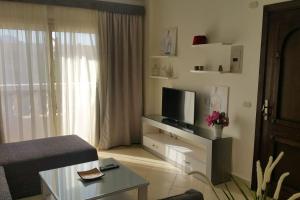 a living room with a tv and a couch at One- bedroom apartment S3 in Vip Zone Sunny Lakes in Sharm El Sheikh
