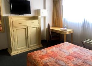 Postel nebo postele na pokoji v ubytování Hotel María Teresa
