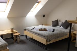 a bedroom with a bed with a table on it at Treehouse Apartments in Martinske Hole