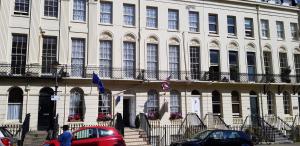 a large white building with cars parked in front of it at Andorra Guest Accommodation in Brighton & Hove +37 photos