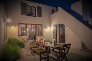 a wooden table with candles on a patio at Sea-Snow Guest Houses in Talmont