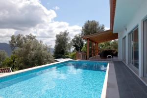 a swimming pool with a view of a house at Gondoriz-House in Terras de Bouro +51 photos